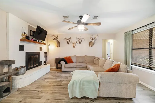 a living room with furniture fireplace and flat screen tv