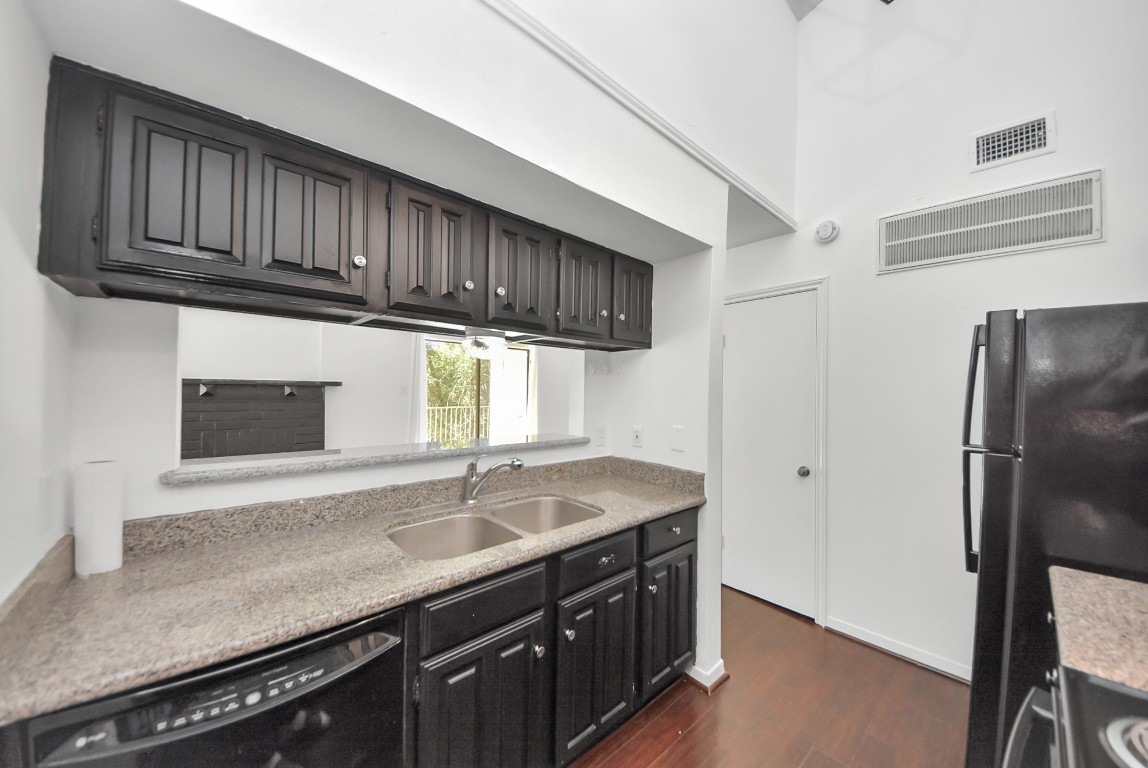3500 Tangle Brush Drive, Unit 8 Spring, TX 77381 - Photo 12 of 32 Kitchen offers a clean, modern look with sleek black cabinetry, countertops, and a double stainless steel sink
