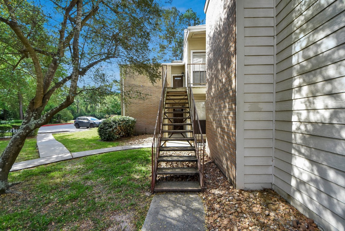 3500 Tangle Brush Drive, Unit 8 Spring, TX 77381 - Photo 26 of 32 Stairs lead up to this second-floor unit overlooking a great view of the lush surrounding landscaping