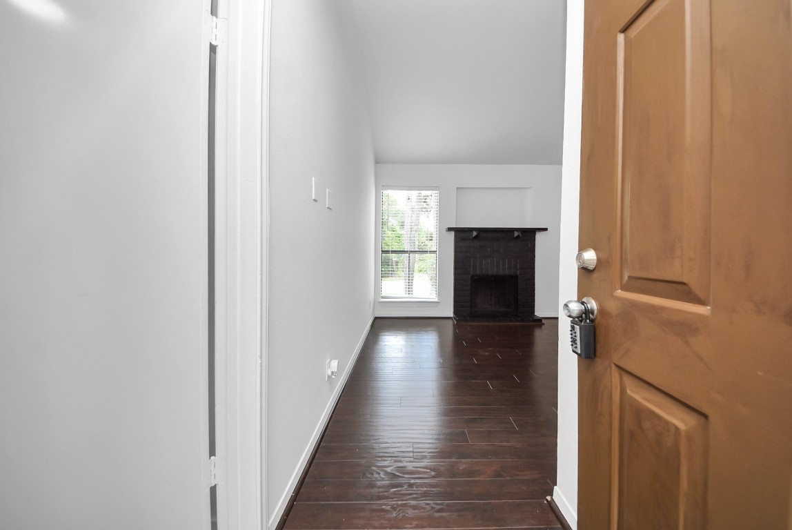 3500 Tangle Brush Drive, Unit 8 Spring, TX 77381 - Photo 28 of 32 Welcome home! The front door opens to a bright living area featuring a striking black brick fireplace and a large window that gives the room with natural light