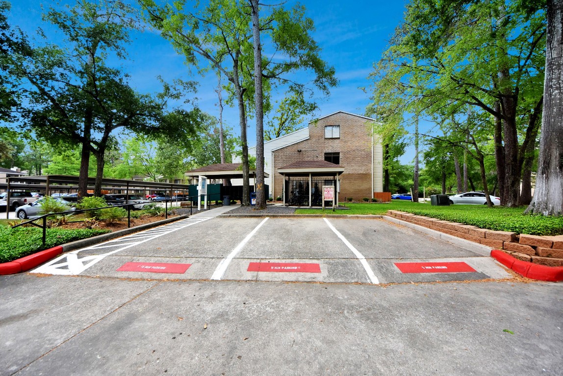 3500 Tangle Brush Drive, Unit 8 Spring, TX 77381 - Photo 29 of 32 A quiet, well-maintained exterior features mature trees and plenty of green space, providing a peaceful park-like setting right outside your door