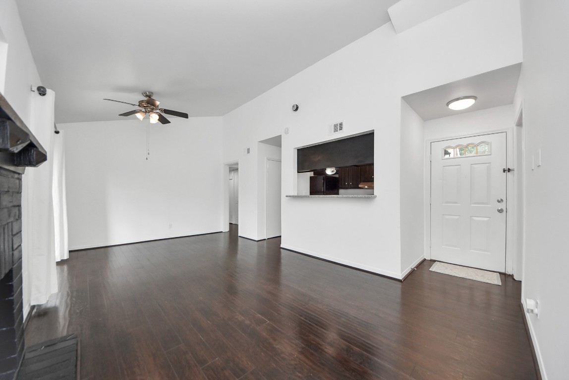 3500 Tangle Brush Drive, Unit 8 Spring, TX 77381 - Photo 3 of 32 Living area flows seamlessly from the entryway, featuring a breakfast bar that connects the kitchen to the room, a ceiling fan provides added comfort