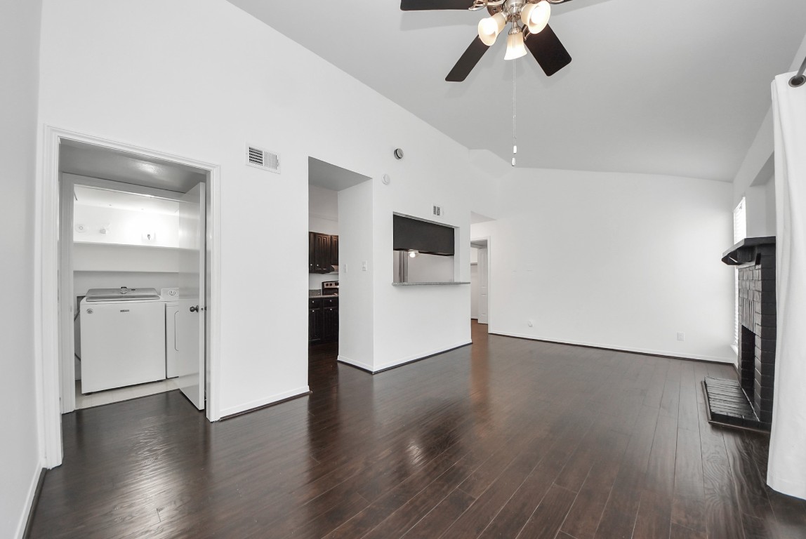 3500 Tangle Brush Drive, Unit 8 Spring, TX 77381 - Photo 4 of 32 Open living area flows seamlessly into the kitchen, featuring vaulted ceilings and a dedicated laundry closet for added convenience