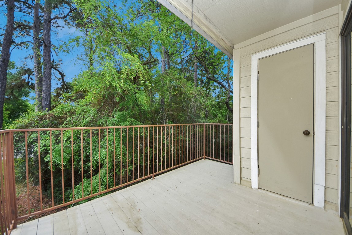 3500 Tangle Brush Drive, Unit 8 Spring, TX 77381 - Photo 7 of 32 Spacious private balcony overlooks a lush, wooded area, offering a quiet outdoor escape