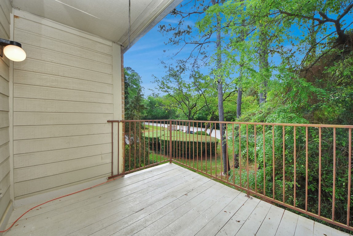 3500 Tangle Brush Drive, Unit 8 Spring, TX 77381 - Photo 8 of 32 Balcony with views of a wooded setting, providing a quiet and relaxing outdoor space