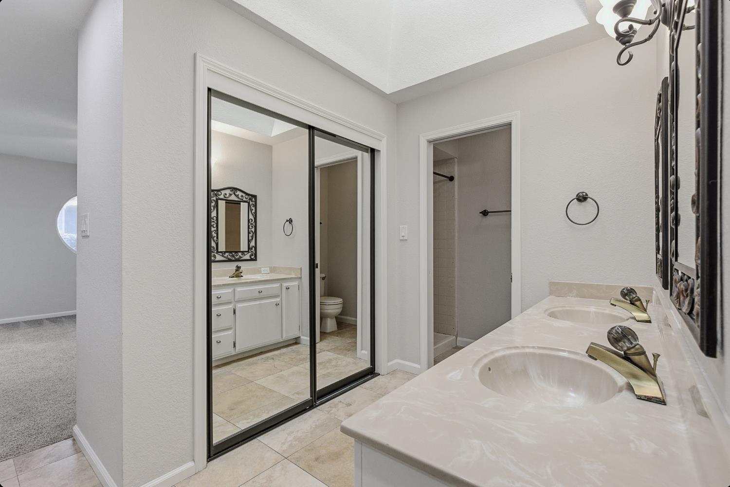 1175 Rose Tree Way Sacramento, CA 95831 - Photo 21 of 33 a bathroom with a sink and a mirror