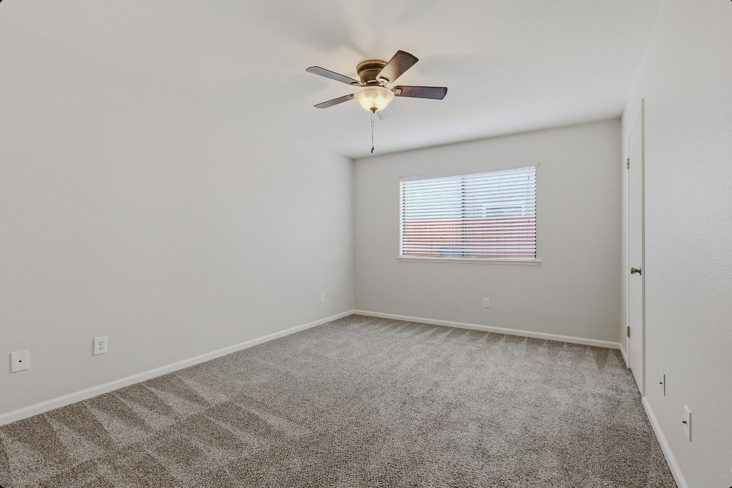 1175 Rose Tree Way Sacramento, CA 95831 - Photo 24 of 33 an empty room with a window and a fan