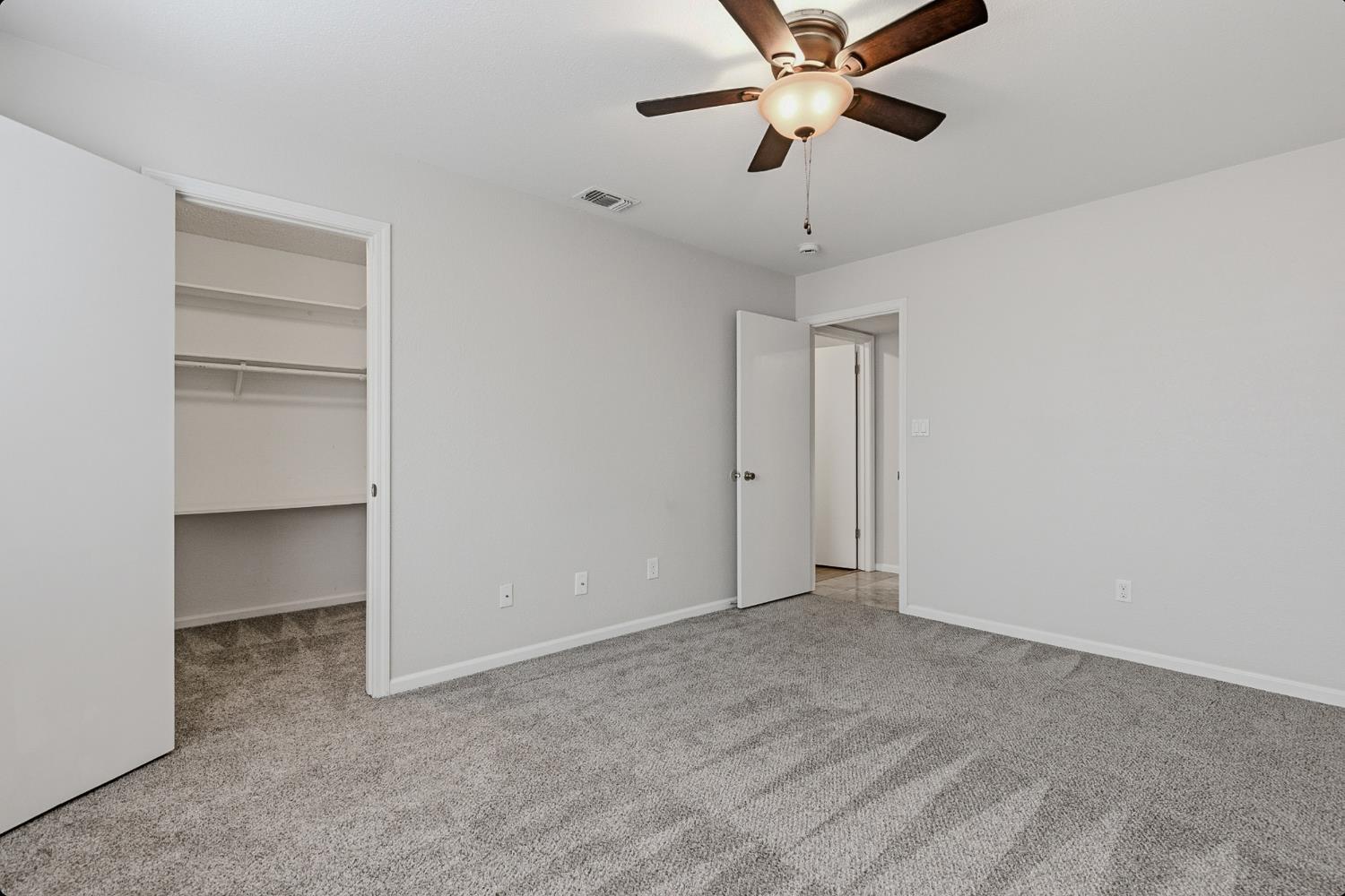 1175 Rose Tree Way Sacramento, CA 95831 - Photo 26 of 33 a view of an empty room with a ceiling fan