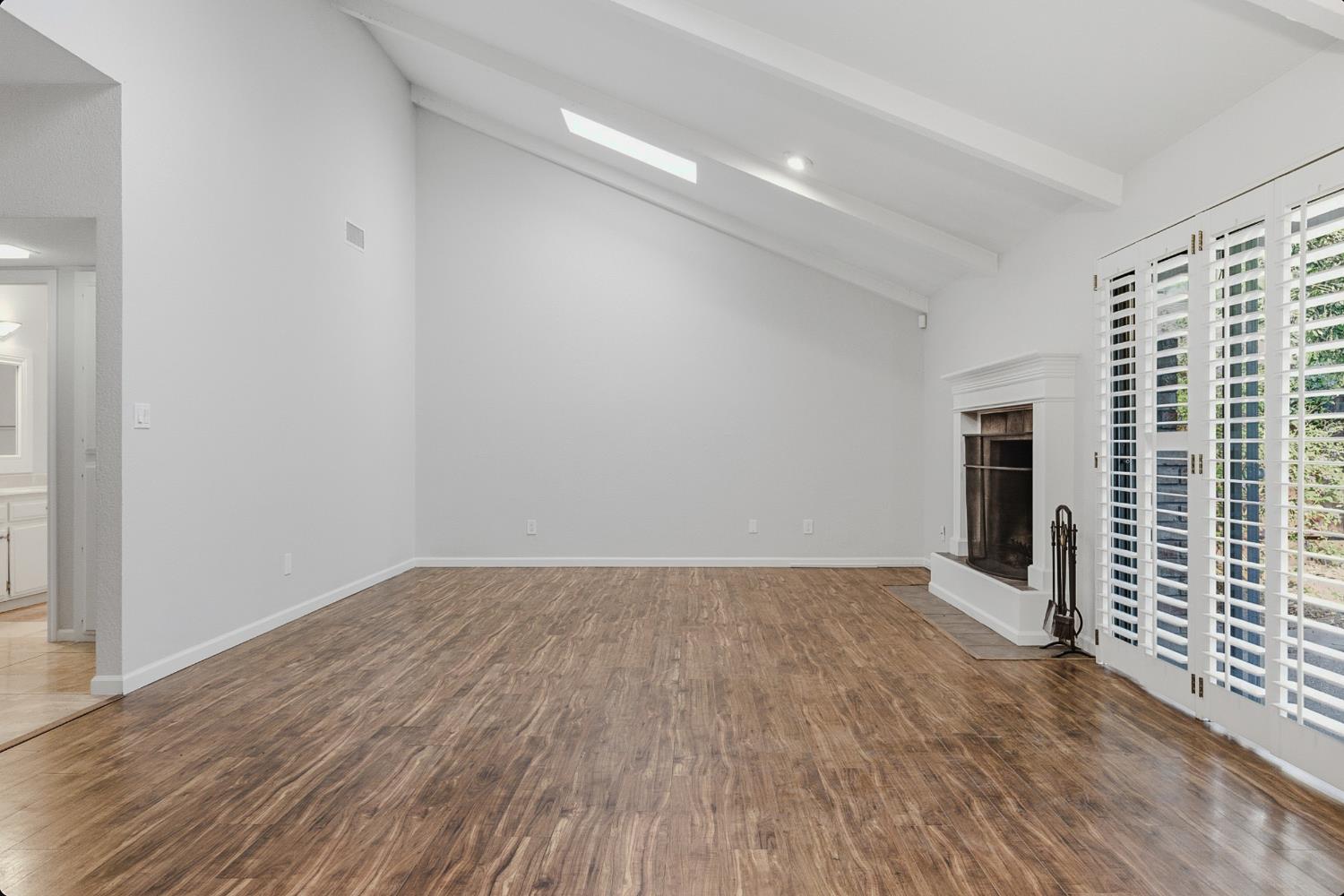1175 Rose Tree Way Sacramento, CA 95831 - Photo 6 of 33 wooden floor in an empty room with a window