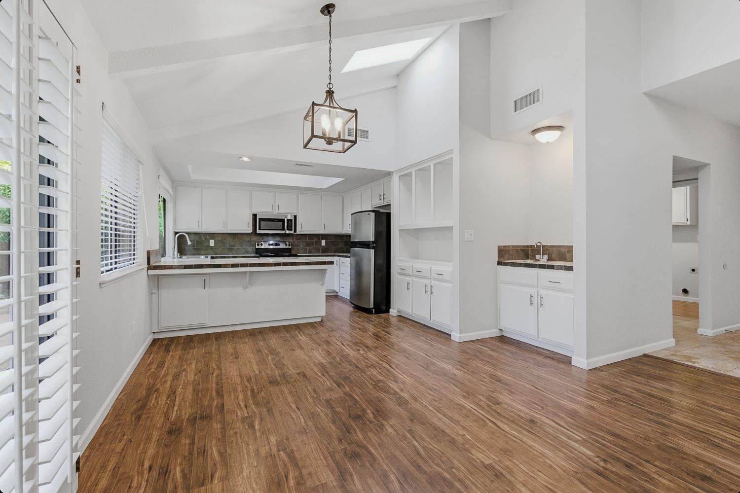 1175 Rose Tree Way Sacramento, CA 95831 - Photo 10 of 33 a kitchen with stainless steel appliances a refrigerator and a stove top oven