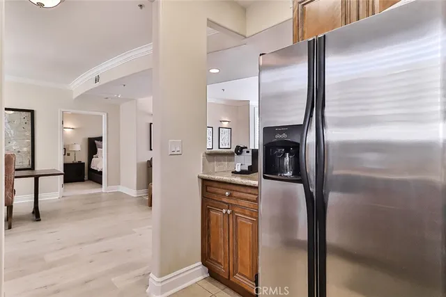 a kitchen with stainless steel appliances granite countertop a refrigerator and a stove