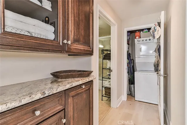 a kitchen with granite countertop stainless steel appliances a refrigerator and a stove top oven