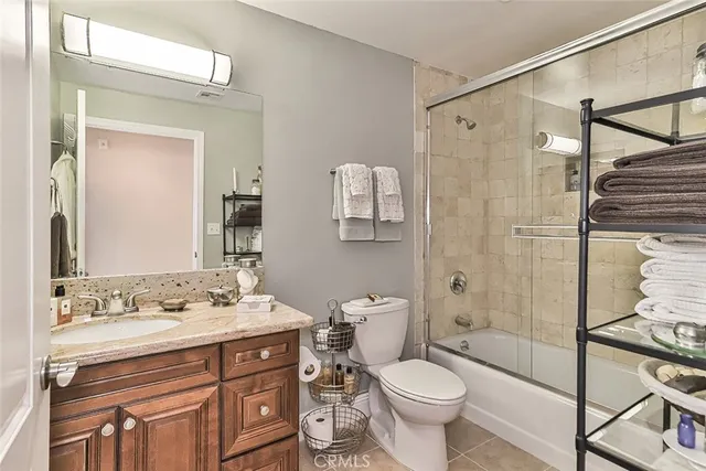 a bathroom with a sink toilet vanity and shower