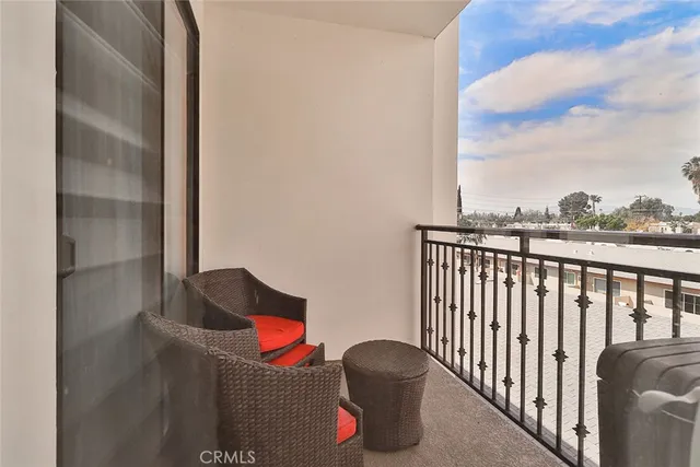 a balcony with an outdoor seating