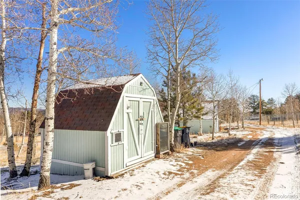 a view of a house with snow on the road