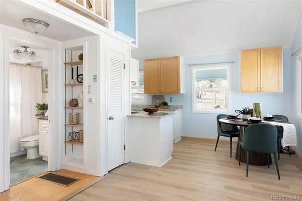 a kitchen with a table chairs refrigerator and cabinets