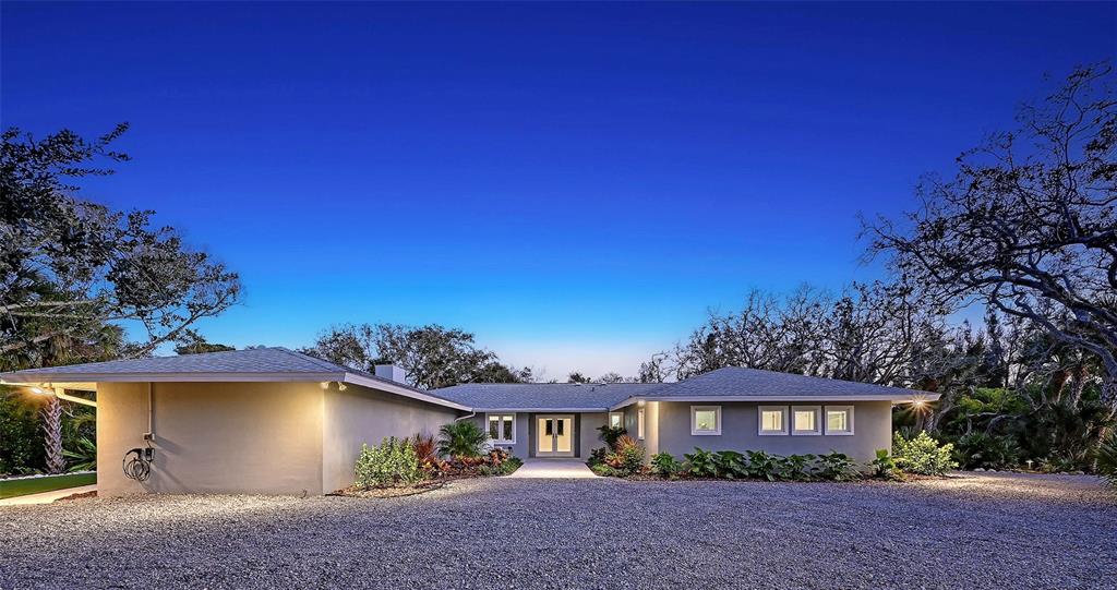 a view of a house with a yard and tree s