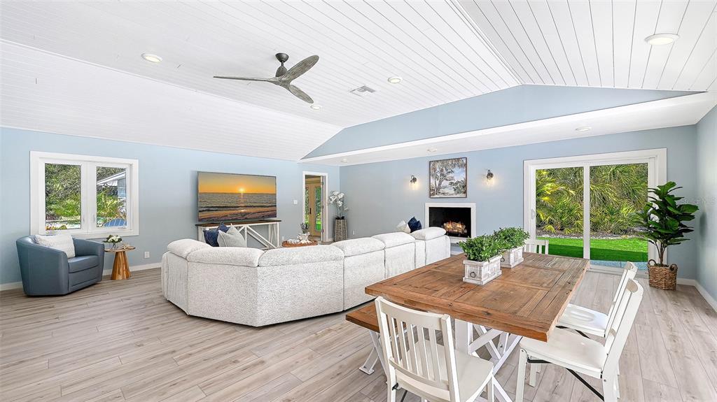 7221 Plovers Way Sarasota, FL 34242 - Photo 11 of 100 a living room with furniture a fireplace and a large window