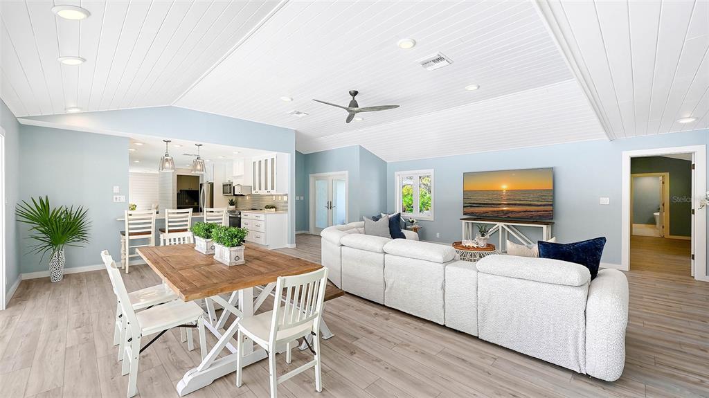 7221 Plovers Way Sarasota, FL 34242 - Photo 12 of 100 a view of a dining room with furniture and wooden floor