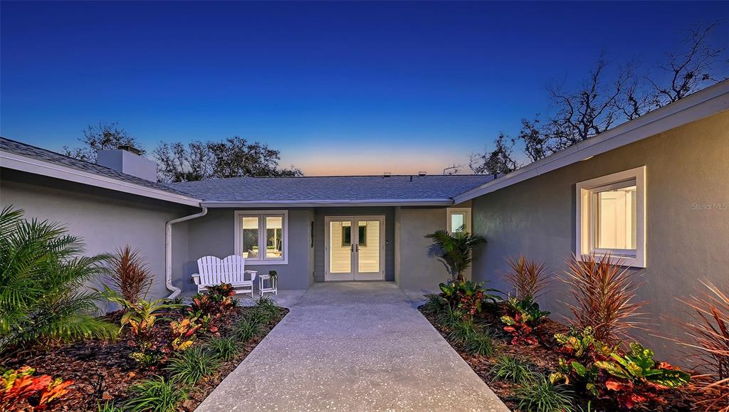 7221 Plovers Way Sarasota, FL 34242 - Photo 2 of 100 a front view of a house with a yard