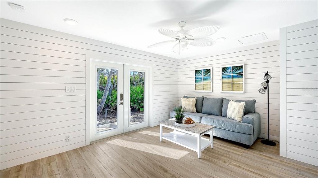 7221 Plovers Way Sarasota, FL 34242 - Photo 22 of 100 a living room with furniture and wooden floor