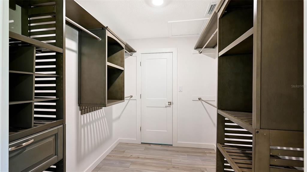 7221 Plovers Way Sarasota, FL 34242 - Photo 28 of 100 a view of a hallway with stairs and wooden floor