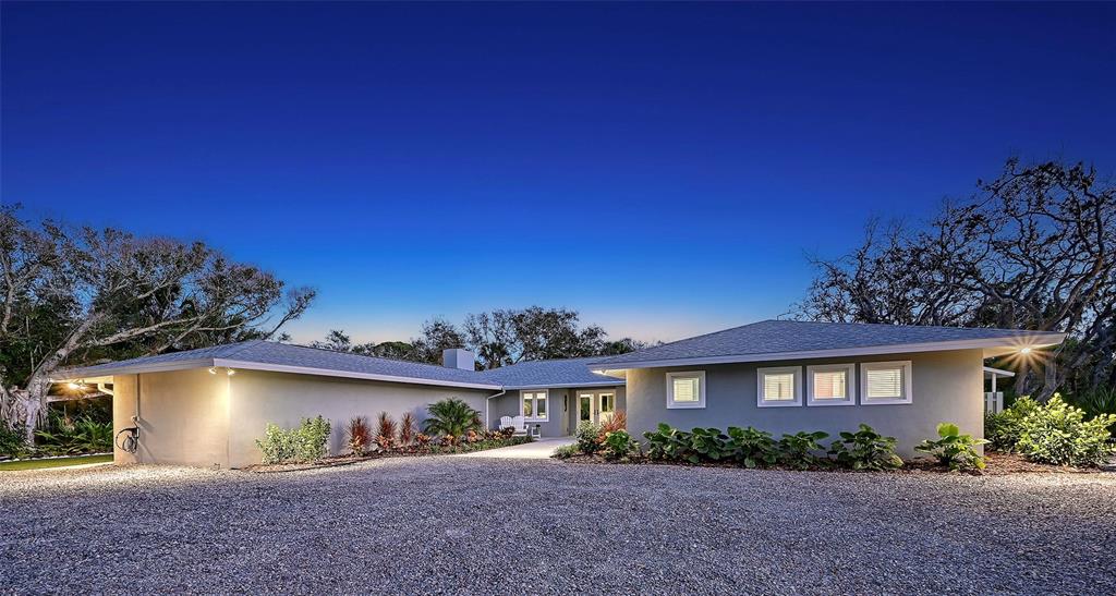 7221 Plovers Way Sarasota, FL 34242 - Photo 3 of 100 a front view of a house with a yard and garage