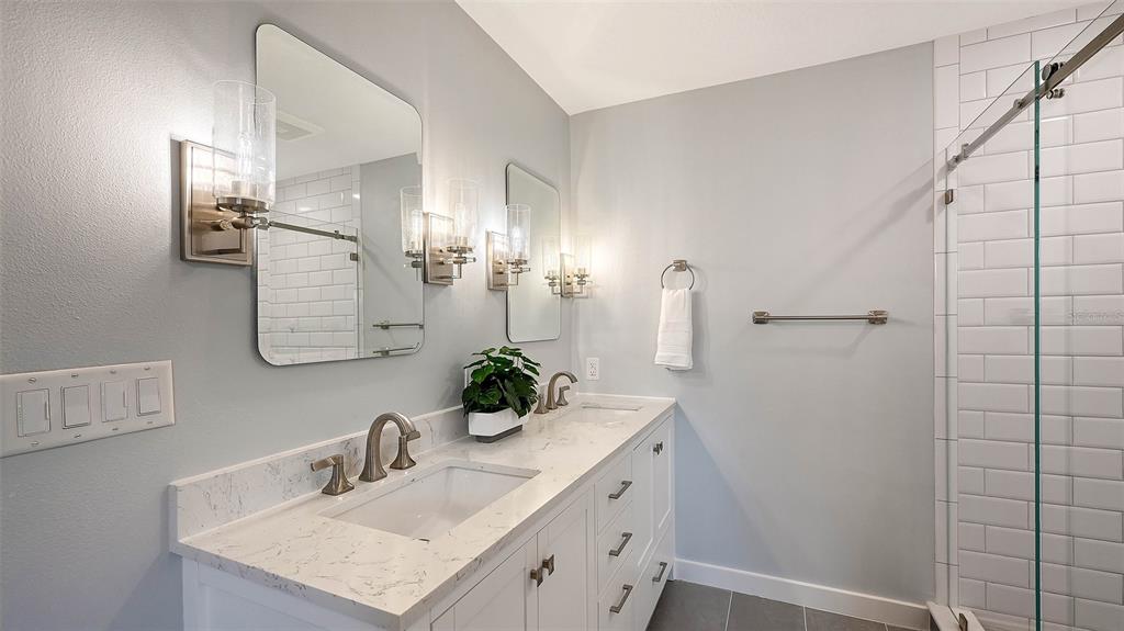 7221 Plovers Way Sarasota, FL 34242 - Photo 41 of 100 a bathroom with a sink and a mirror