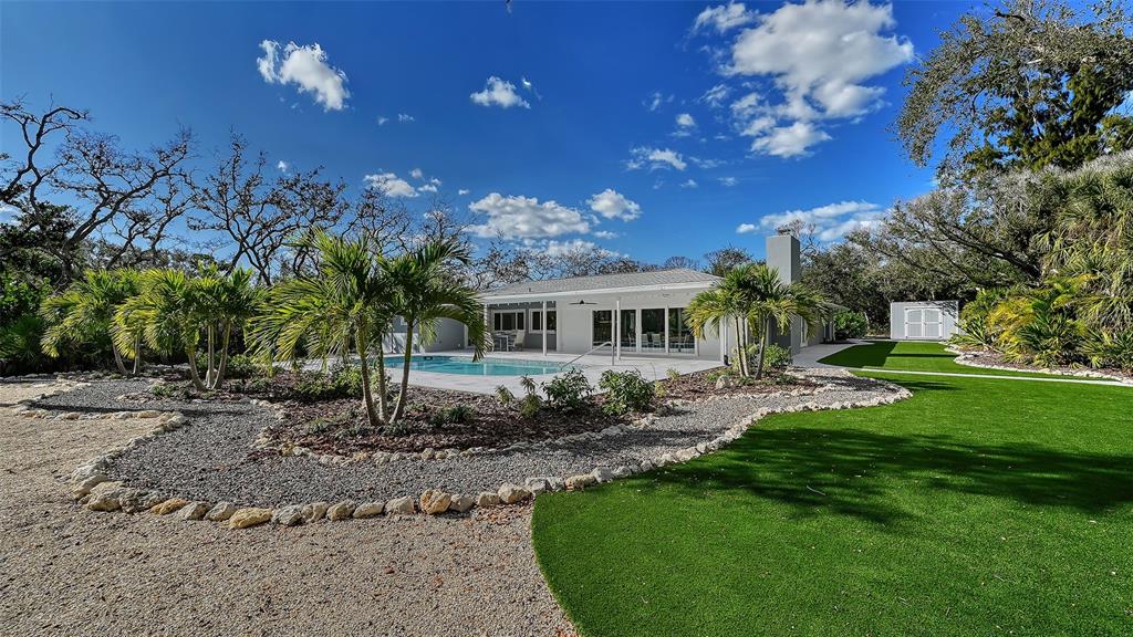 7221 Plovers Way Sarasota, FL 34242 - Photo 65 of 100 a front view of a house with garden