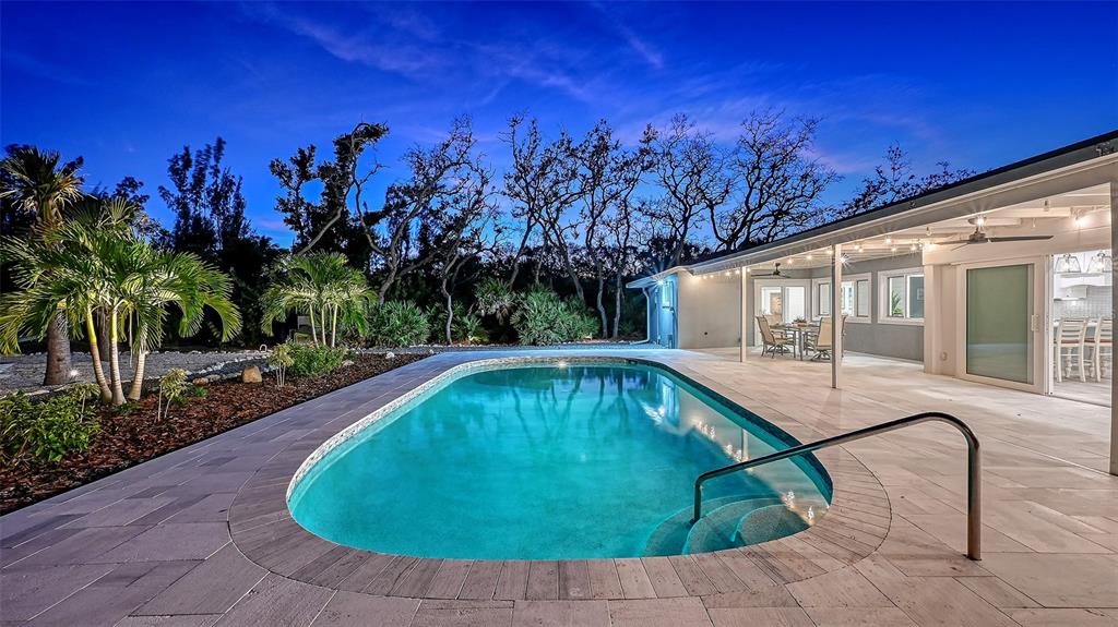 7221 Plovers Way Sarasota, FL 34242 - Photo 77 of 100 a swimming pool with outdoor seating and yard