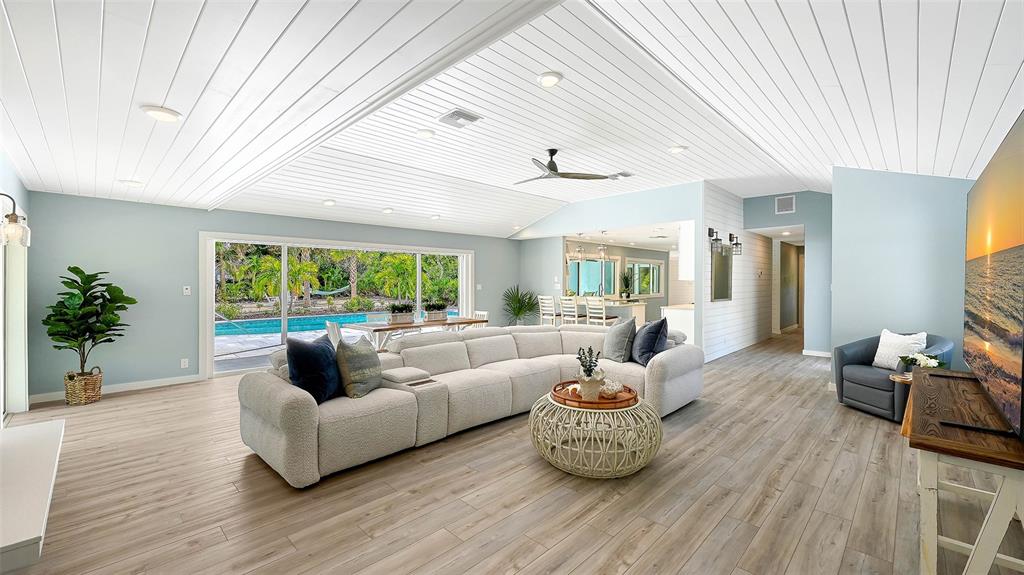 7221 Plovers Way Sarasota, FL 34242 - Photo 8 of 100 a living room with furniture and a large window