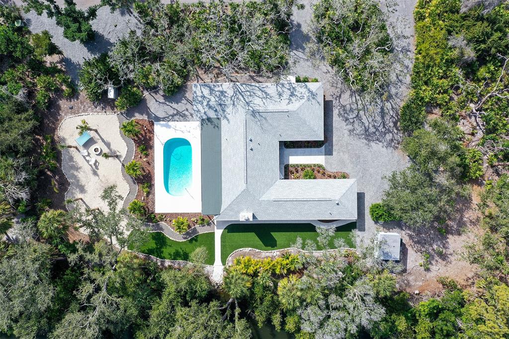 7221 Plovers Way Sarasota, FL 34242 - Photo 82 of 100 an aerial view of a house with a yard and large trees