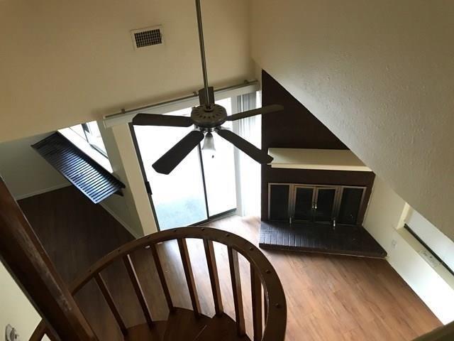 2500 Burleson Road, Unit 312 Austin, TX 78741 - Photo 4 of 6 A spacious living area with warm wood flooring and a cozy fireplace.