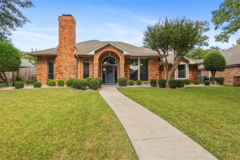 1901 Drew Lane Richardson, TX 75082 - Photo 1 of 1 a front view of a house with garden