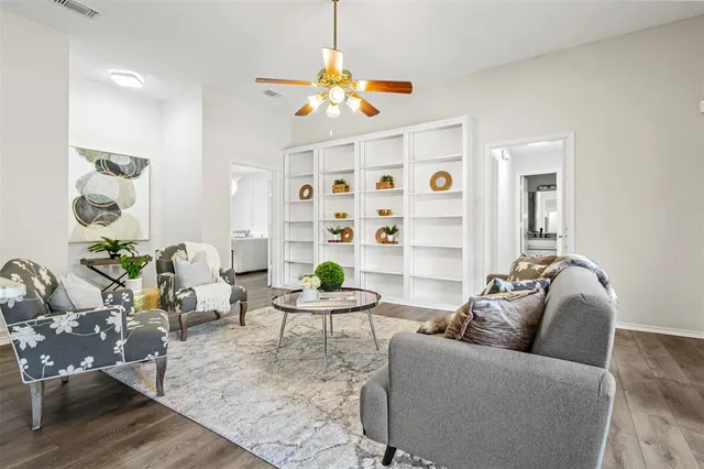 a living room with furniture and wooden floor
