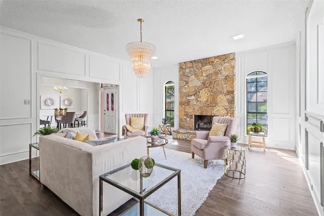 a living room with fireplace furniture and a wooden floor