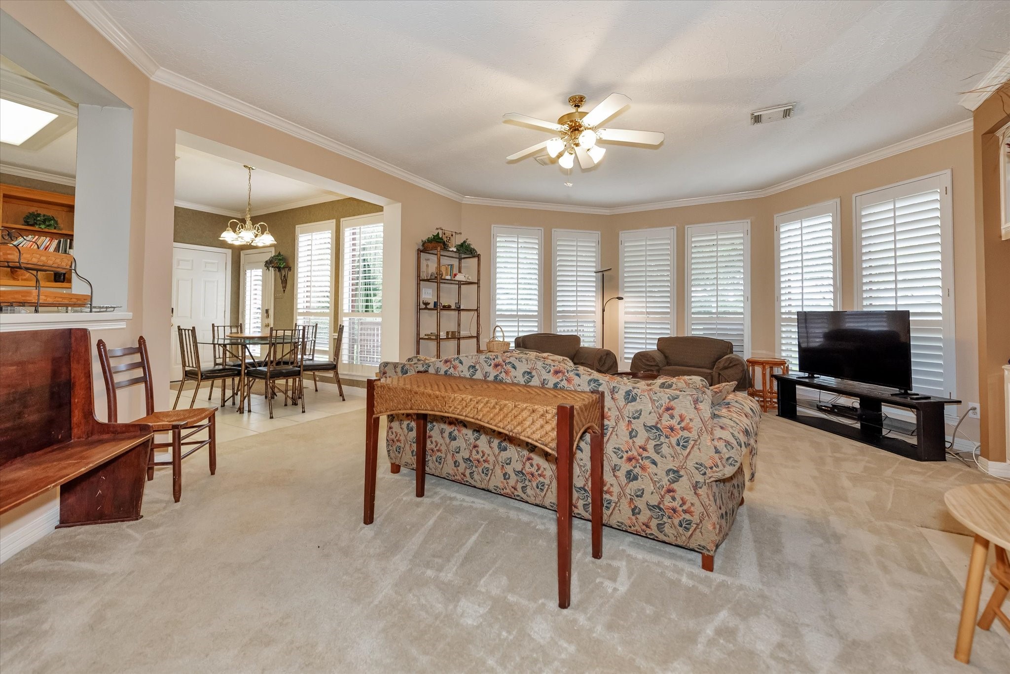 5718 Oakmoss Trail Spring, TX 77379 - Photo 12 of 48 a living room with furniture and a flat screen tv