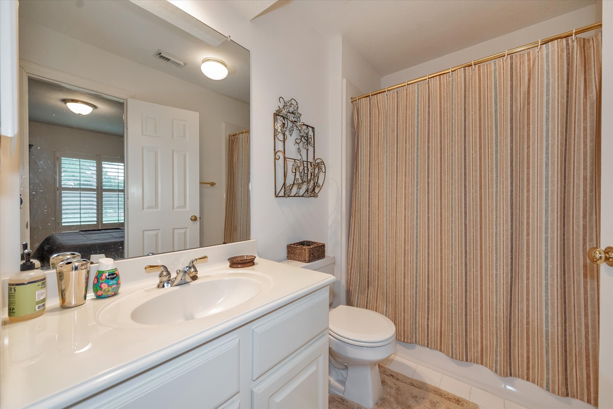 5718 Oakmoss Trail Spring, TX 77379 - Photo 29 of 48 a bathroom with a sink a toilet and shower