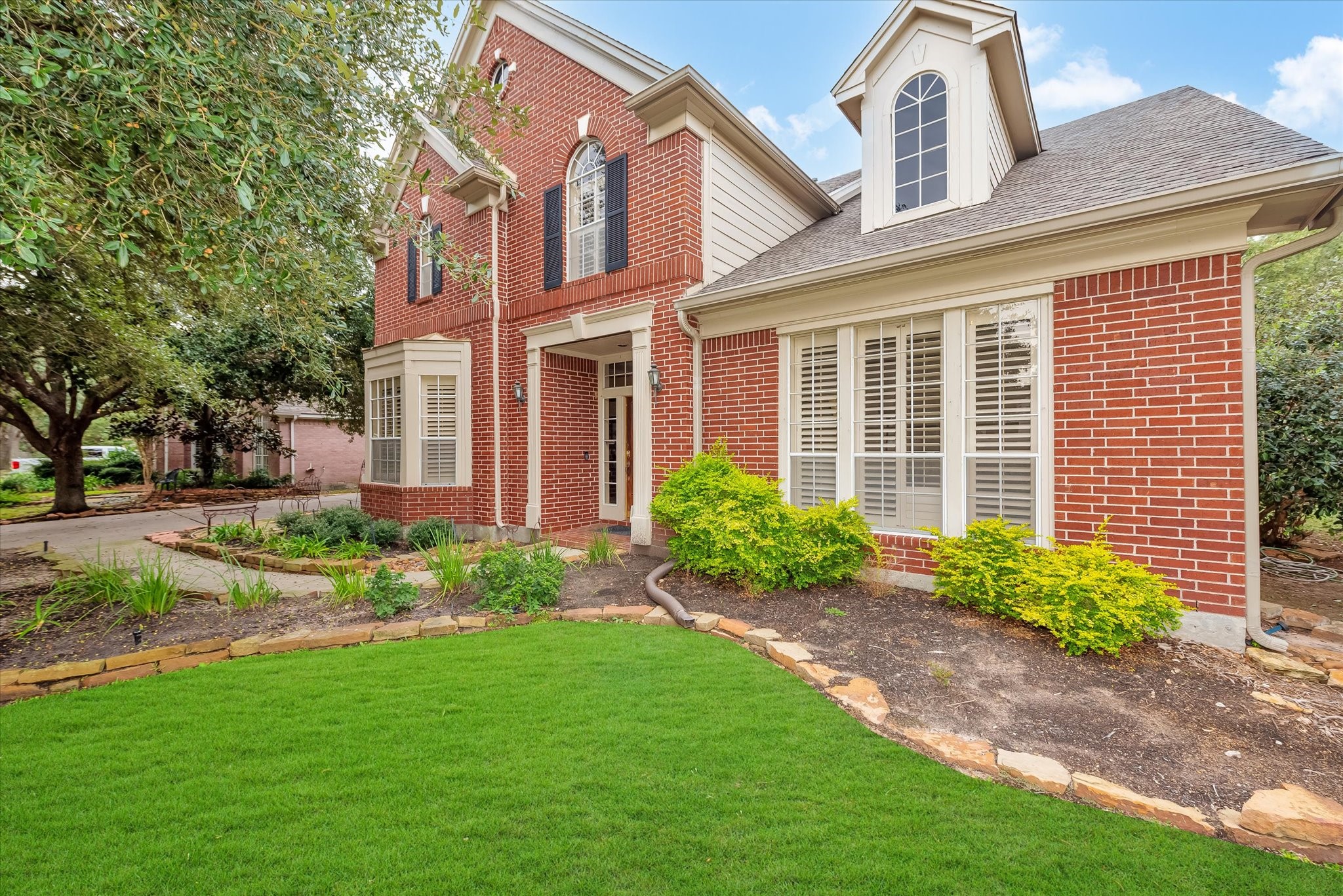 5718 Oakmoss Trail Spring, TX 77379 - Photo 3 of 48 a front view of a house with garden