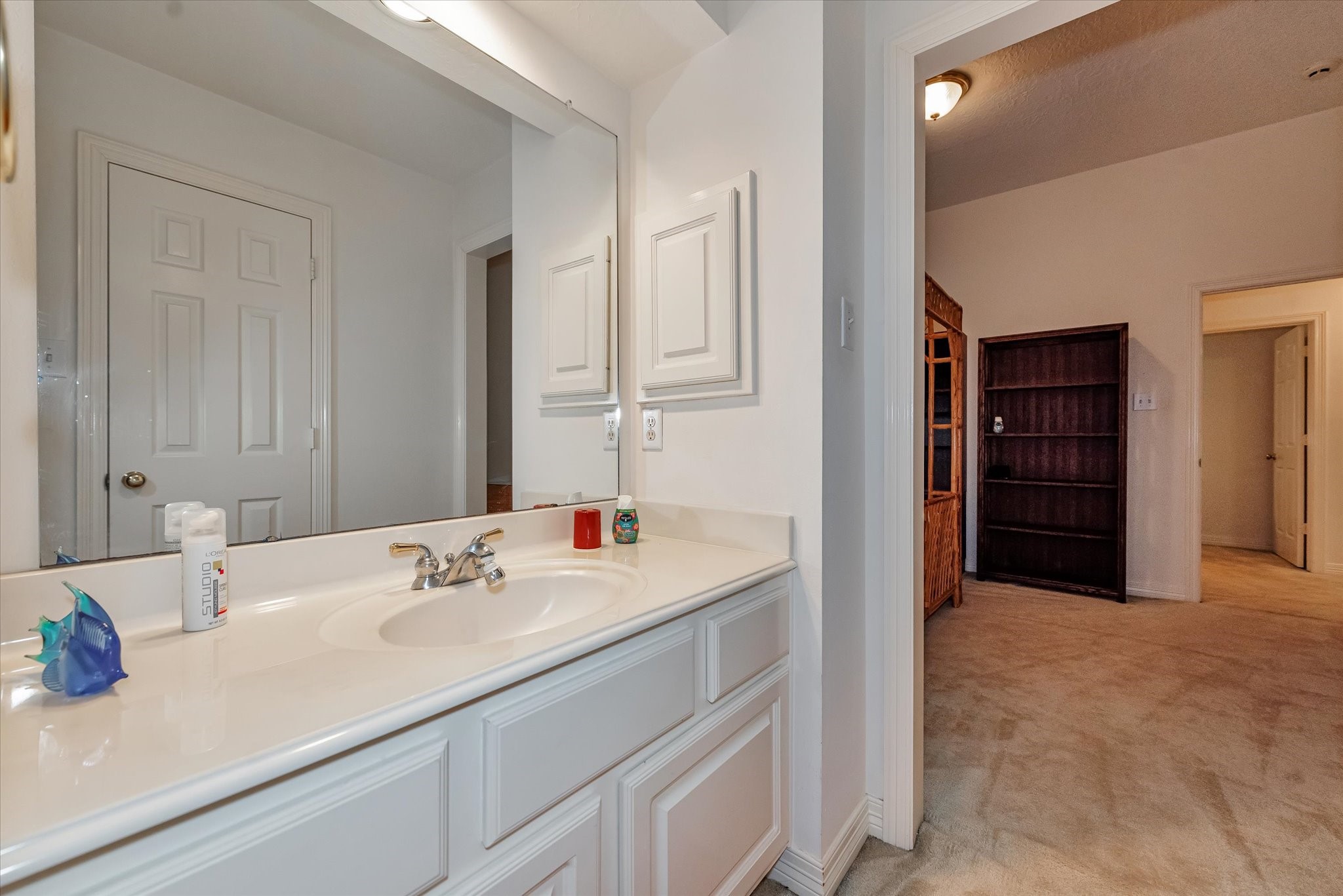 5718 Oakmoss Trail Spring, TX 77379 - Photo 32 of 48 a bathroom with a sink and a mirror