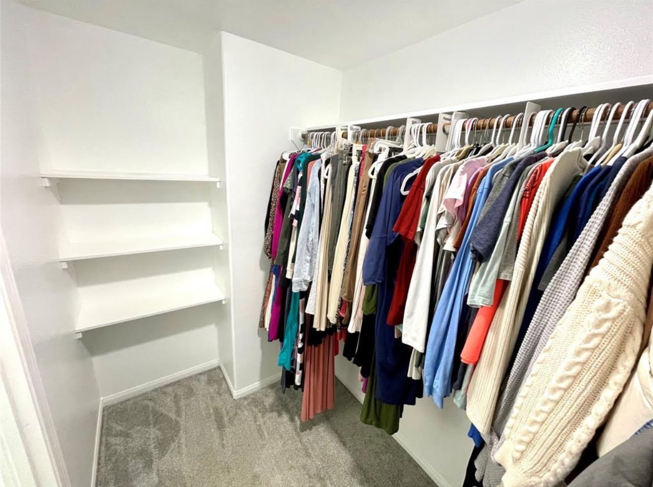 1811 Tickner Street Conroe, TX 77301 - Photo 11 of 20 a view of walk in closet with clothes and shoes