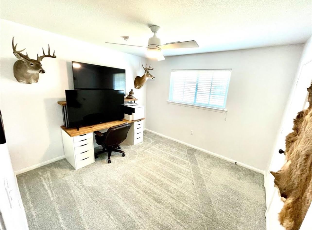 1811 Tickner Street Conroe, TX 77301 - Photo 14 of 20 a living room with furniture and a flat screen tv