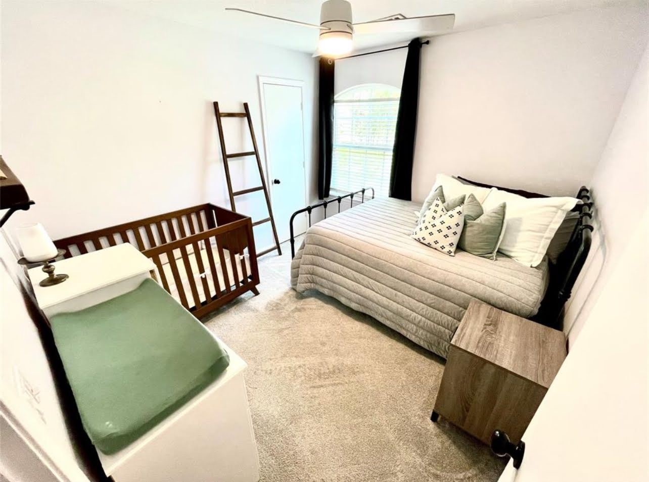 1811 Tickner Street Conroe, TX 77301 - Photo 16 of 20 a bedroom with a bed and a mirror