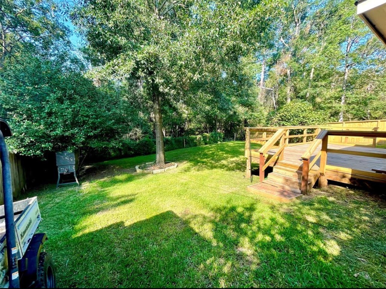 1811 Tickner Street Conroe, TX 77301 - Photo 19 of 20 a view of a backyard with swimming pool
