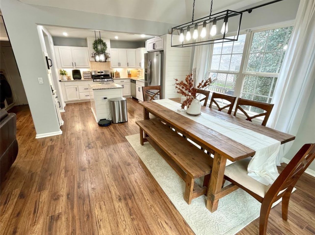 1811 Tickner Street Conroe, TX 77301 - Photo 5 of 20 a living room with stainless steel appliances kitchen island granite countertop furniture a large window a sink and a counter top space