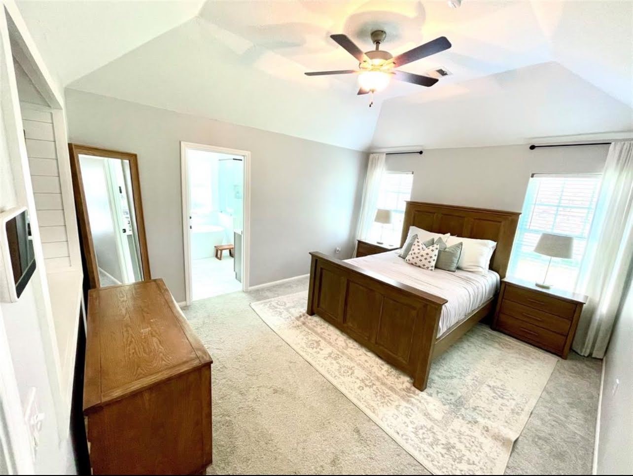 1811 Tickner Street Conroe, TX 77301 - Photo 8 of 20 a bedroom with a bed a dresser and potted plant