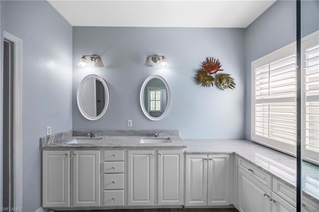 3589 Periwinkle Way Naples, FL 34114 - Photo 14 of 39 a bathroom with mirror and sink