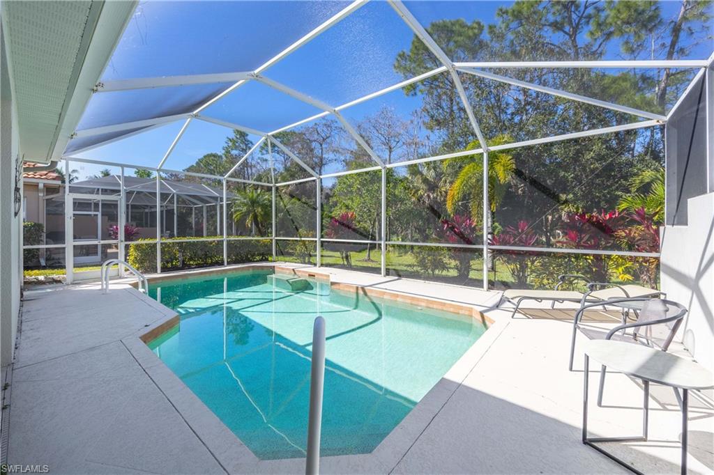 3589 Periwinkle Way Naples, FL 34114 - Photo 20 of 39 a view of a backyard with a swimming pool