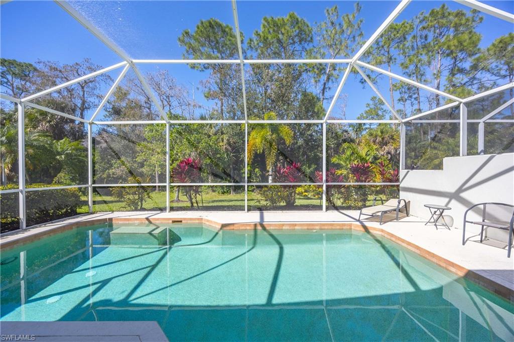 3589 Periwinkle Way Naples, FL 34114 - Photo 21 of 39 a view of a backyard with a patio and swimming pool