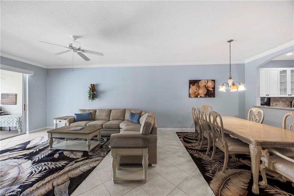 3589 Periwinkle Way Naples, FL 34114 - Photo 5 of 39 a living room with furniture and a table